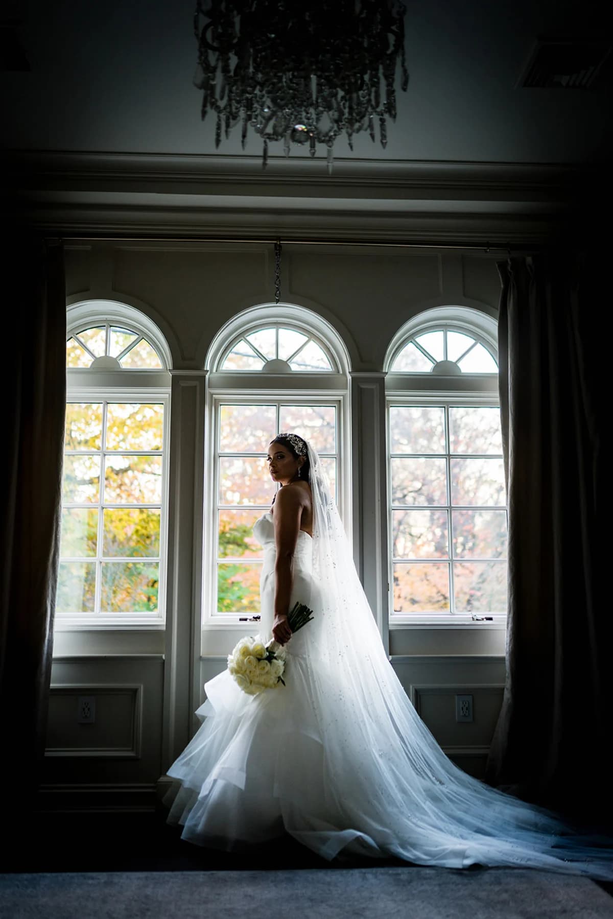 Judy in front of three arched windows at Nanina’s In the Park