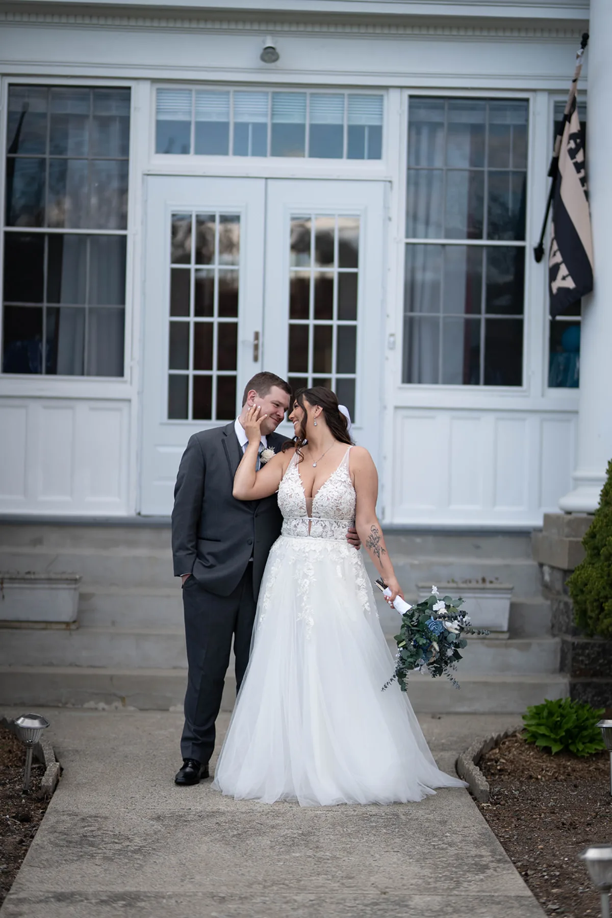 Couple embracing on the clubhouse steps at The Club at Picatinny