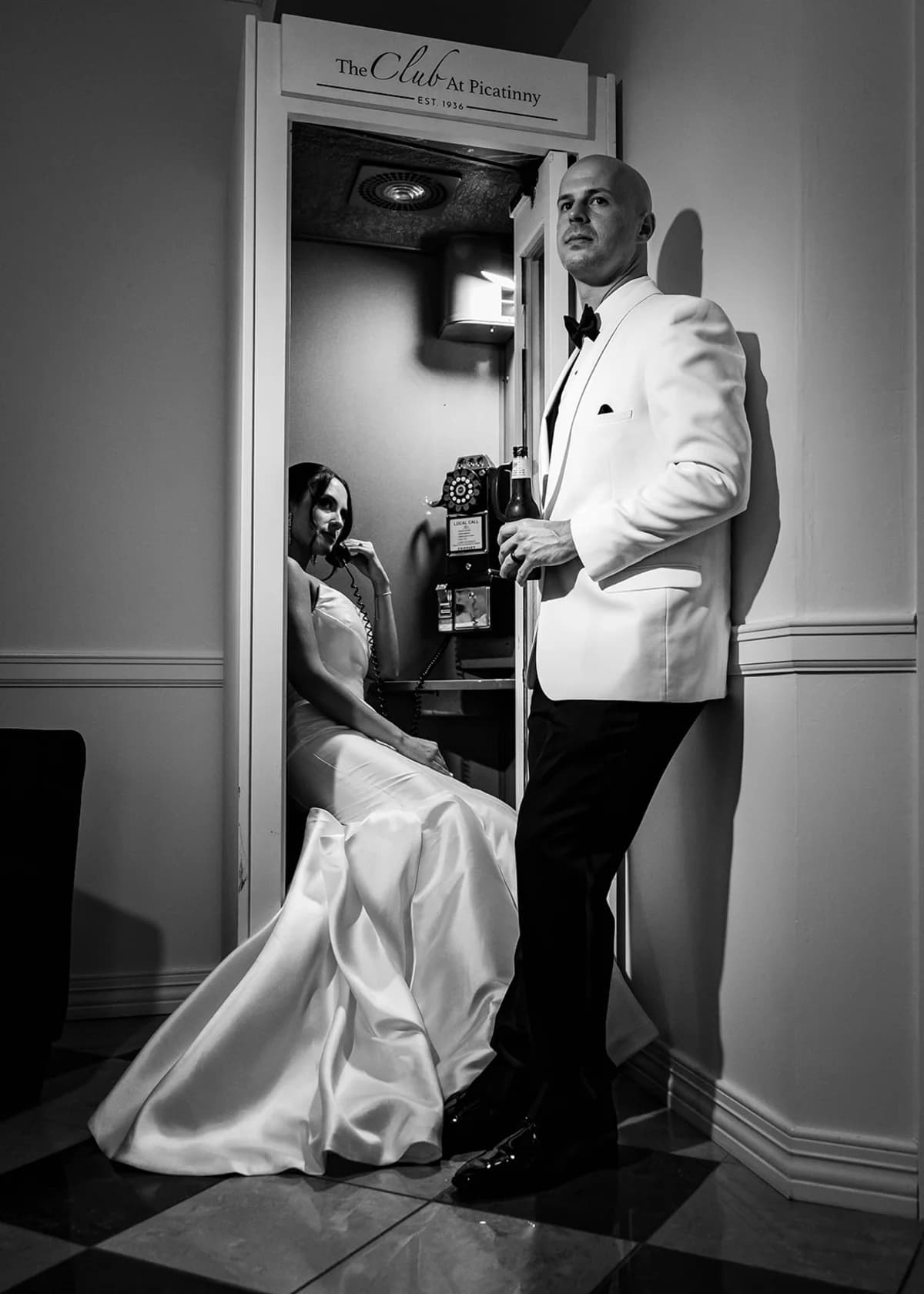 Black-and-white portrait of the couple by a window at The Club at Picatinny