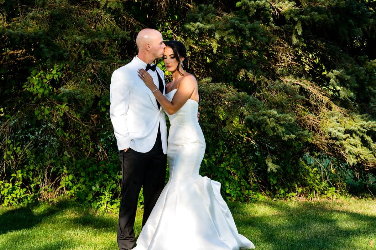 Couple portrait among the trees on the grounds at The Club at Picatinny