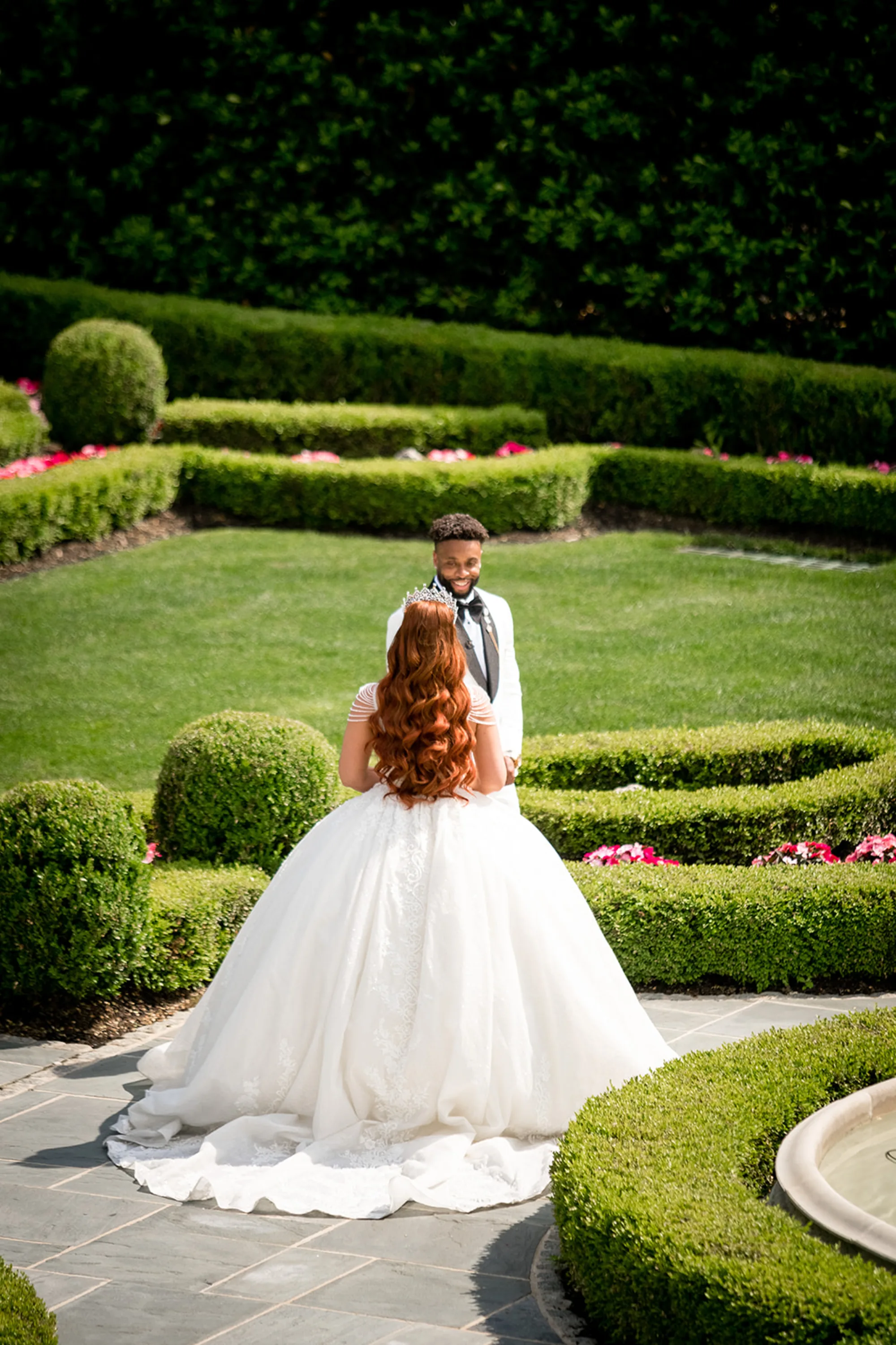 Jeffrey turning to see Bianca for the first time in the formal garden at Park Chateau