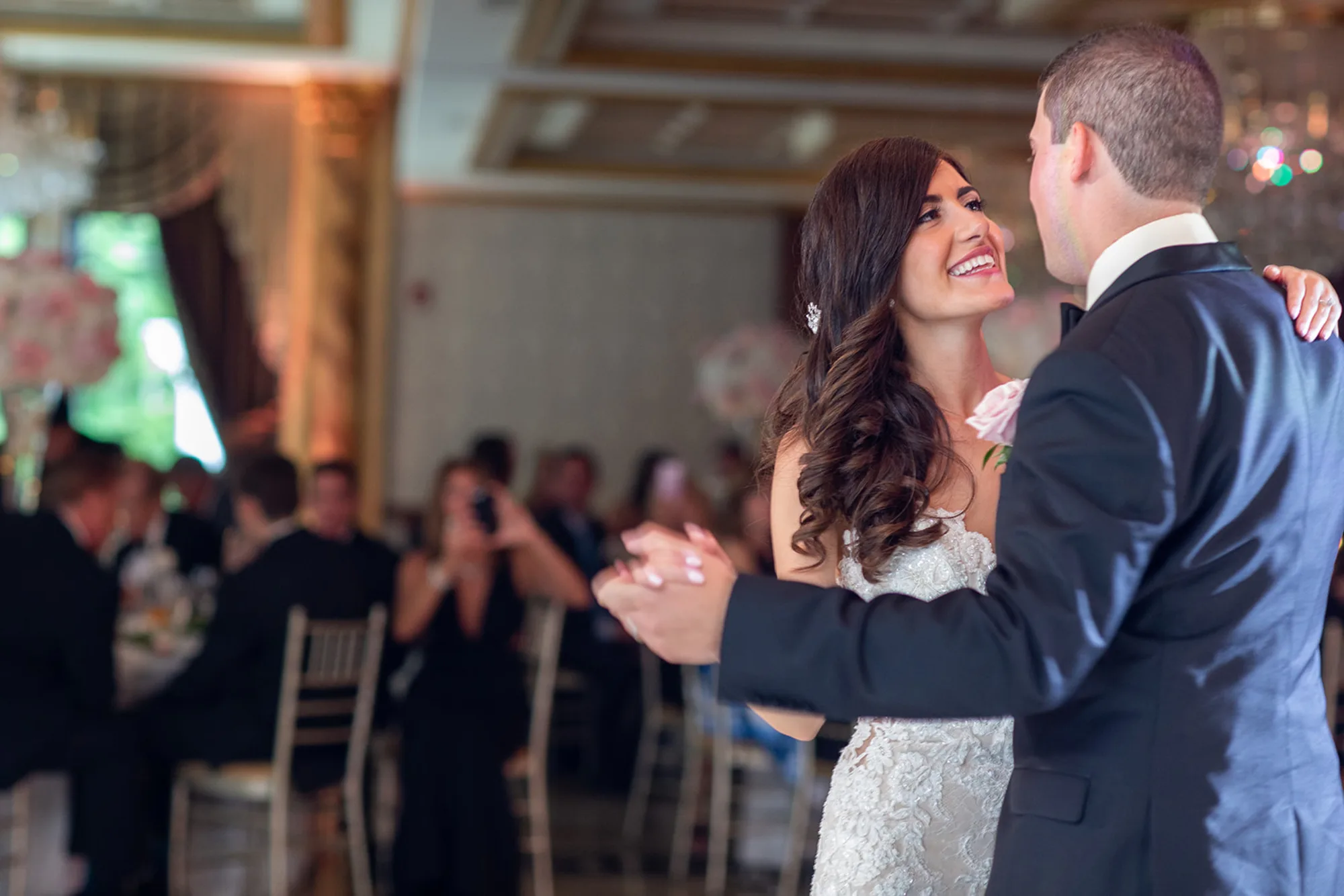 Karni and Zilvinas’s first dance at The Venetian while guests photograph them from their seats