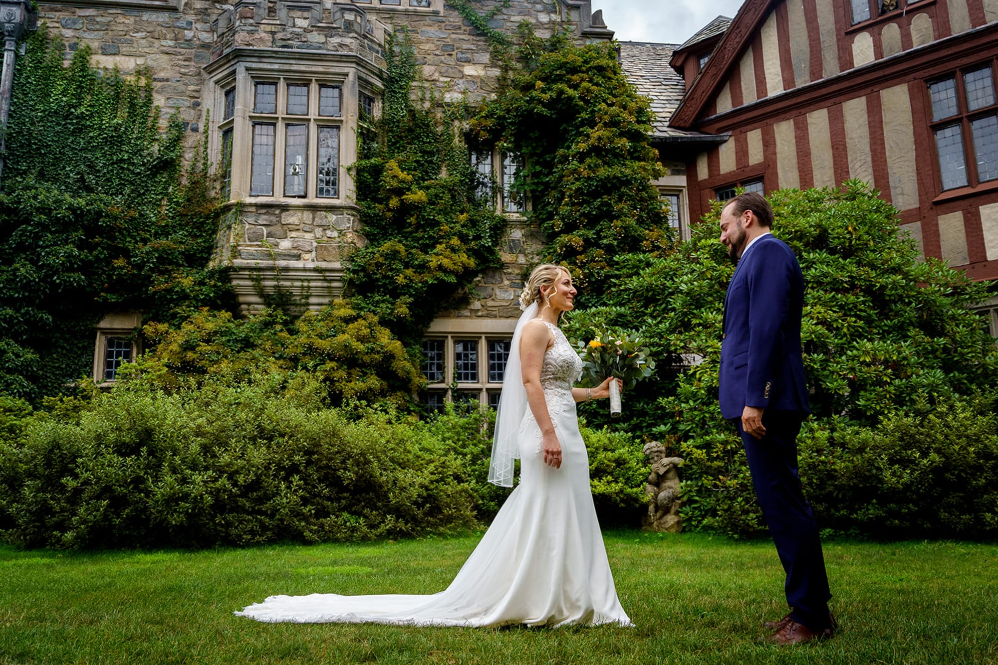 Crysta and David’s first look on the lawn in front of the Tudor stone facade of Skylands Manor