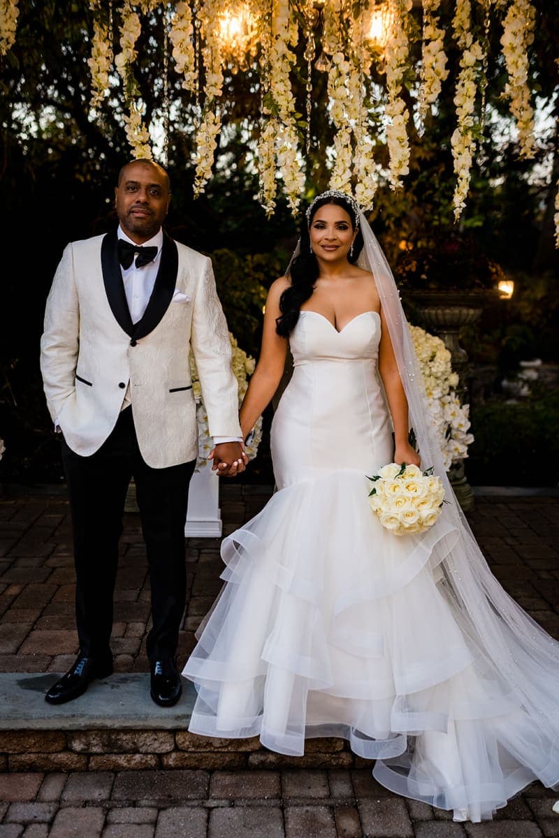 Bride and groom under floral gazebo