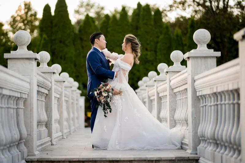 Amanda and Alex on the balustraded bridge at The Mansion on Main Street at golden hour