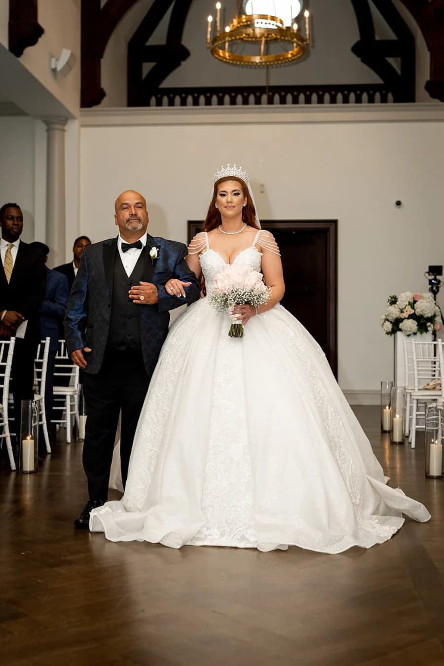 Bianca walking down the aisle on her father’s arm at Park Chateau
