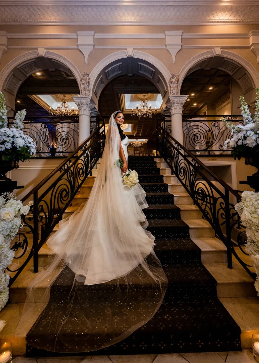 Judy on the grand staircase at Nanina’s In the Park, veil trailing behind
