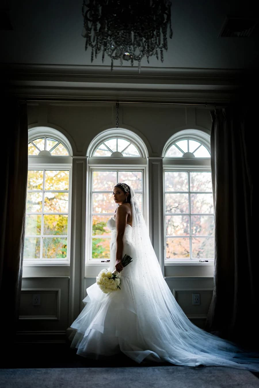 Judy in front of three arched windows at Nanina’s In the Park