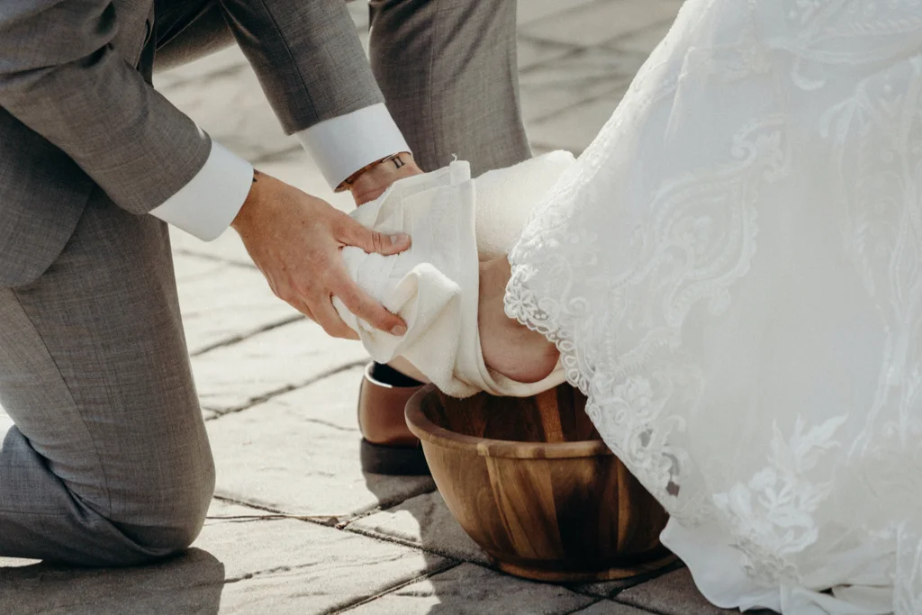 Groom washing bride's feet